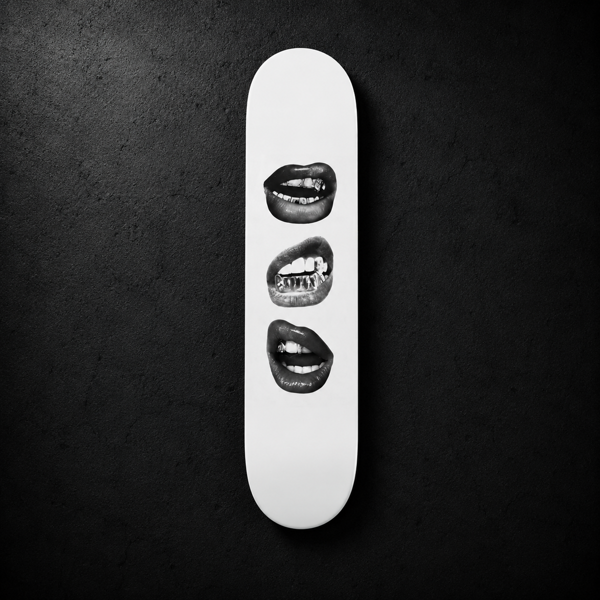 Lips wall skate deck by SeventySeven.DC — white deck with three black and white photographic mouths, mounted on a dark concrete wall